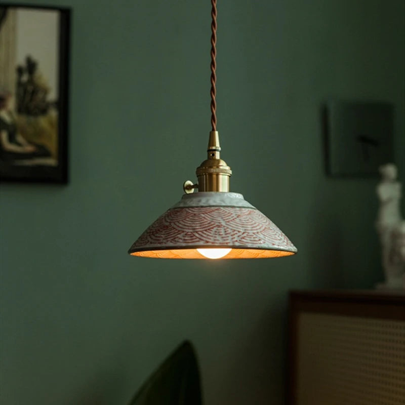 Hand-painted ceramic pendant light with red wave pattern and LED bulb, ideal for elegant home lighting.