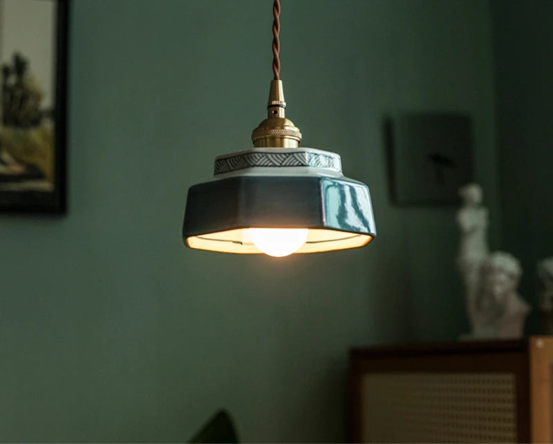 LED ceramic pendant lamp in glossy blue with copper fixture, adding vintage charm to a contemporary living space.