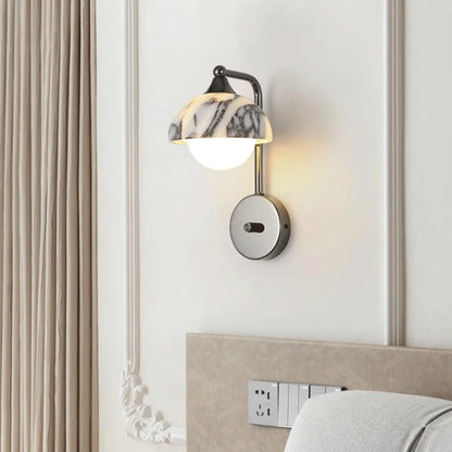 Stone light wall sconce with alabaster shade mounted in a stylish bedroom, offering warm LED illumination and decorative appeal.
