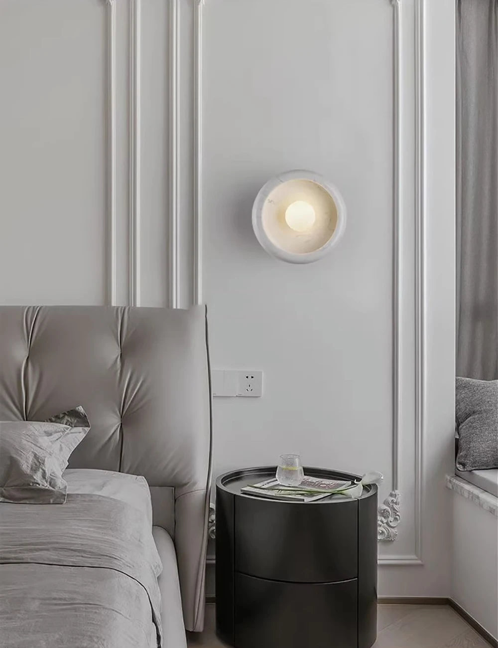 White Jade Wall Lamp beside a bed with tufted headboard, offering soft LED glow for cozy and elegant bedroom lighting.