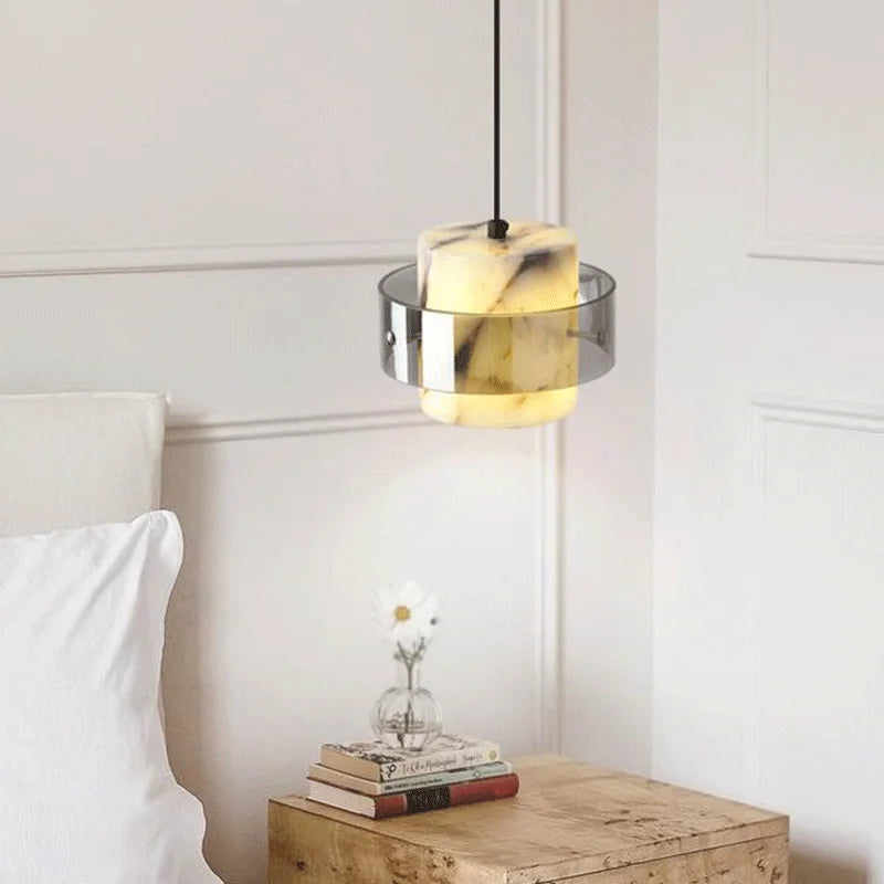 LED Marble Pendant Light hanging above a bedside table, adding a warm, elegant touch to modern bedroom decor.
