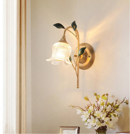 LED French Wall Sconce Light with golden floral design mounted in a living room, adding vintage charm to home decor with soft ambient lighting.