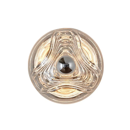 Designer glass wall lamp with round sculpted LED fixture in clear glass, ideal for modern kitchen or restaurant sconce lighting.