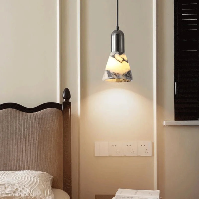 Dark Marble LED Pendant - Modern Ceiling Light illuminating a bedroom wall, featuring a marble-textured shade and adjustable hanging wire.