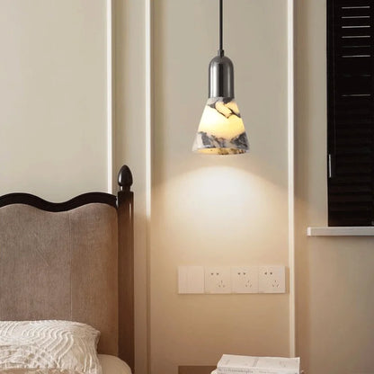 Dark Marble LED Pendant - Modern Ceiling Light illuminating a bedroom wall, featuring a marble-textured shade and adjustable hanging wire.