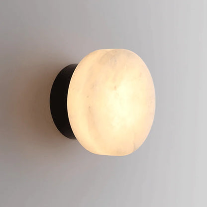 Modern LED Marble Wall Lamp with round Spanish marble shade and black base, ideal for living room or corridor lighting.