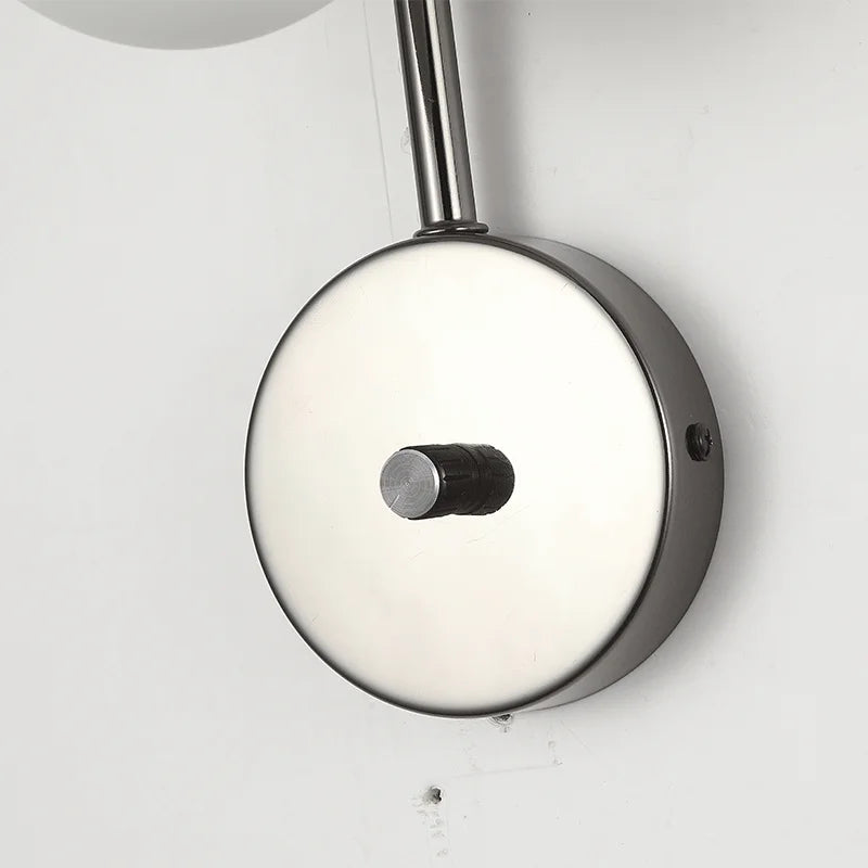 Close-up of the round metal wall mount base of the alabaster wall sconce, showcasing its sleek and modern finish.