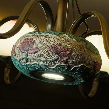 Close-up of lotus blossom LED chandelier base with intricate ceramic floral design, showcasing craftsmanship and elegance.