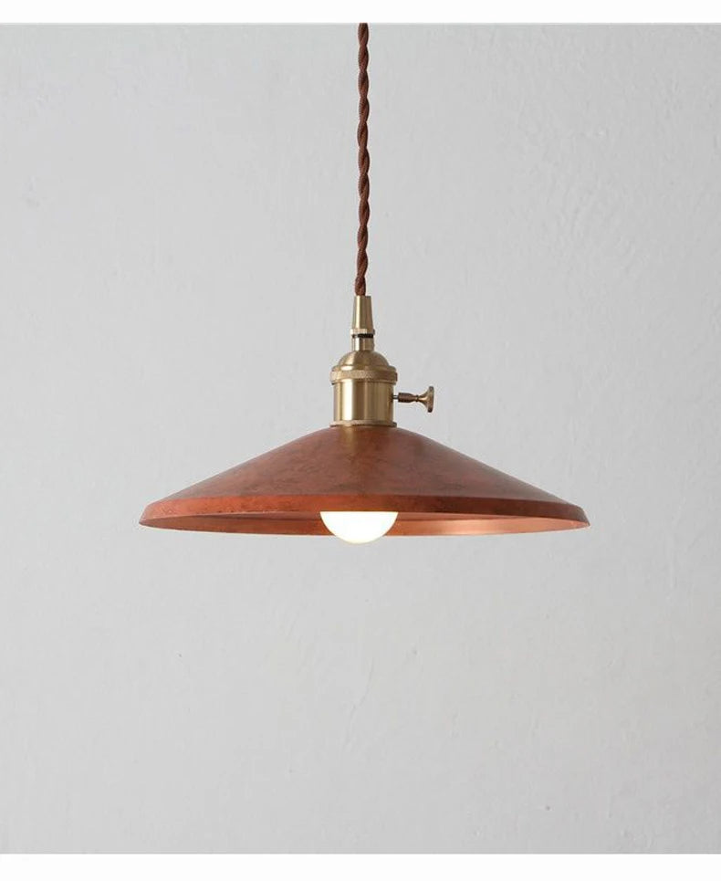 Rustic copper Industrial Brass Pendant Light with warm bulb, ideal for cozy restaurant or bar lighting.