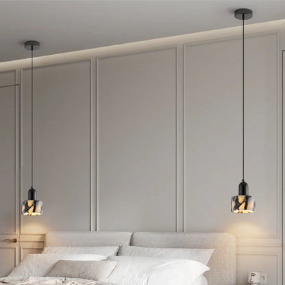 Pair of Black Marble Pendant Lights with Nordic LED above a bed, offering symmetrical and modern bedroom illumination.