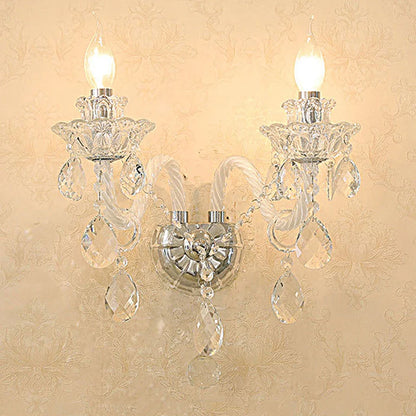 Illuminated vintage lotus crystal wall lamp with clear crystals and LED bulbs, enhancing French-style interior ambiance.
