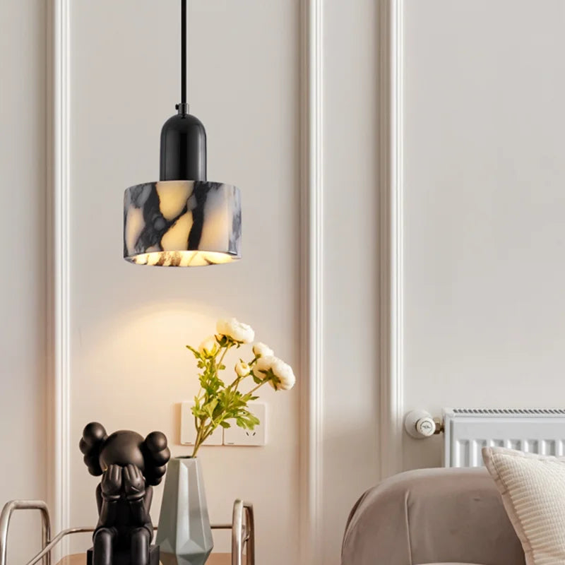 Nordic LED Black Marble Pendant Light hanging in a stylish bedroom, blending modern elegance with soft ambient lighting.