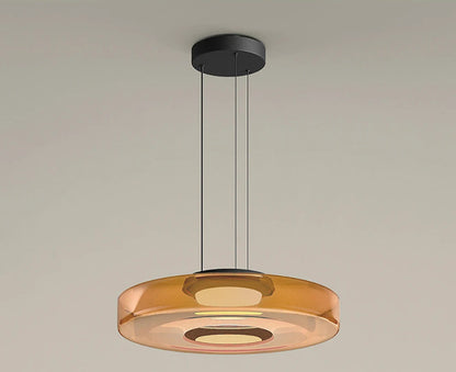 Amber glass pendant light with 45cm diameter and 11cm height. LED light source and adjustable hanging wire for modern interiors.
