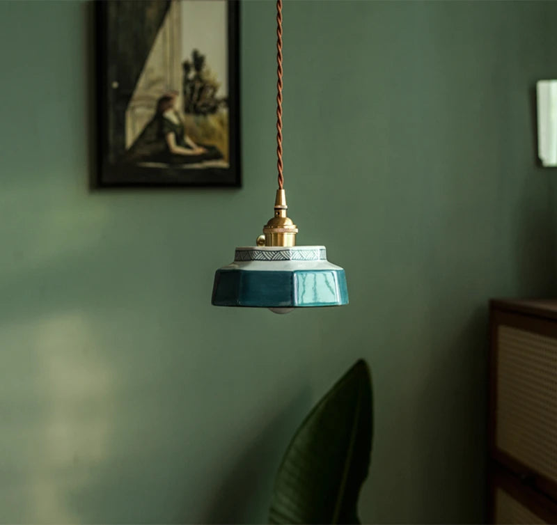 Modern blue ceramic pendant light with LED bulb, hanging in a stylish interior for ambient home lighting.