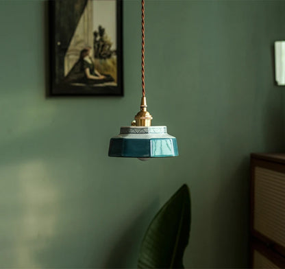 Modern blue ceramic pendant light with LED bulb, hanging in a stylish interior for ambient home lighting.