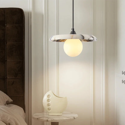 Black LED Marble Pendant Light in a minimalist bedroom, suspended above a marble side table for a stylish and functional lighting solution.