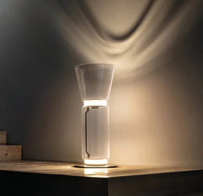 Italian minimalist glass floor lamp – nordic design with LED lighting and clear glass, casting elegant wall shadows.