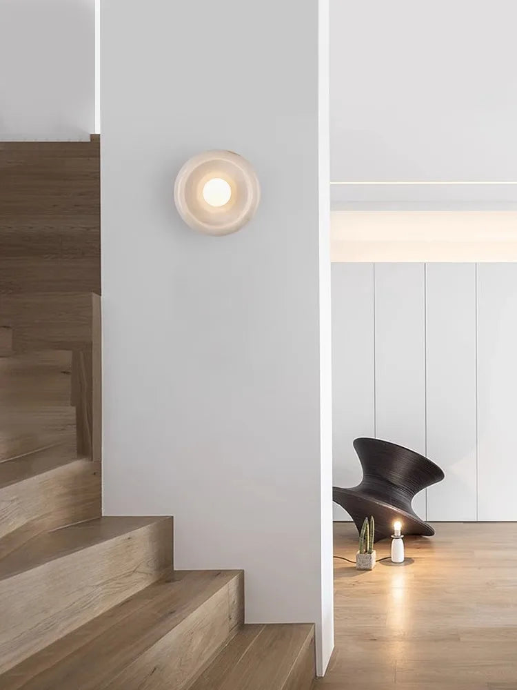 Jade Wall Lamp mounted on a white wall near a staircase, providing soft LED lighting and elegant accent for contemporary home interiors.