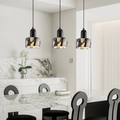 Three Black Marble Pendant Lights with Nordic LED style suspended above a marble kitchen island, creating a luxurious modern look.