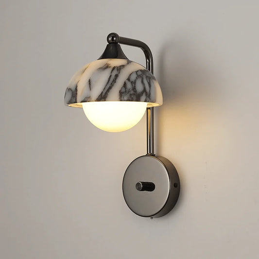 Alabaster wall sconce with black stone shade and LED bulb, mounted on a neutral wall. Ideal for bedroom or hallway lighting.