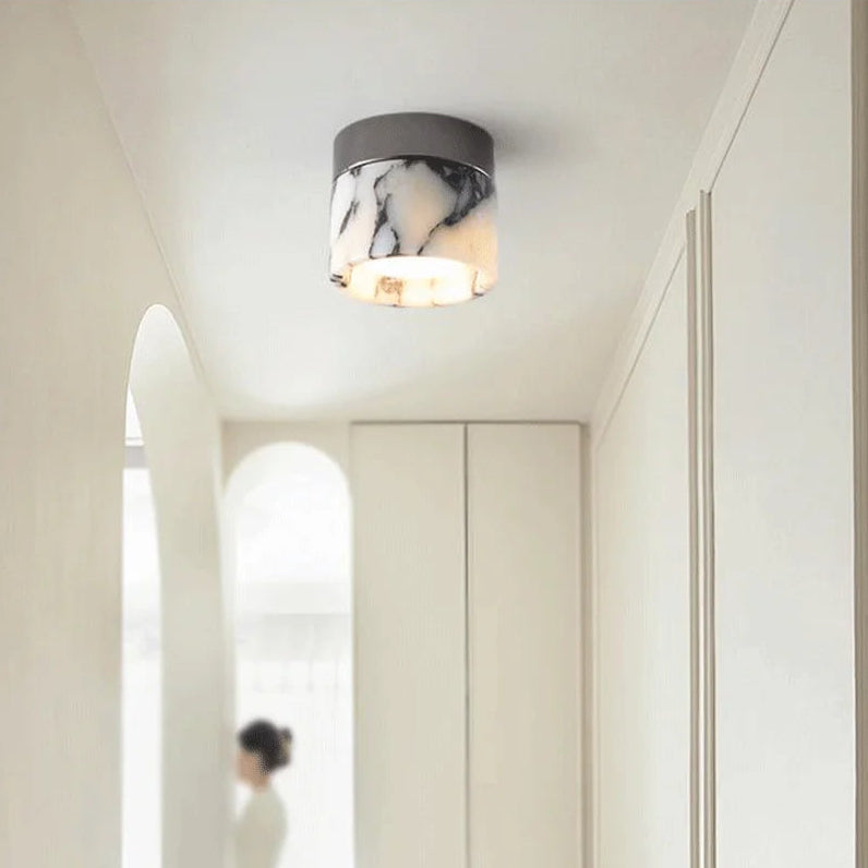 Nordic LED wall sconce mounted in a minimalist hallway, blending marble glass and modern design for soft, elegant illumination.