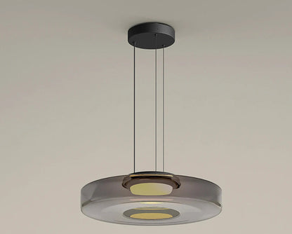 Smoke grey glass pendant light with 45cm diameter and 11cm height. Features LED lighting and adjustable suspension.