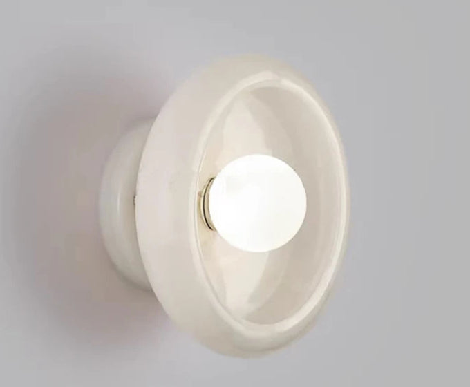 White Jade Wall Lamp turned on, emitting soft LED light and enhancing bedroom or living room ambiance with minimalist elegance.