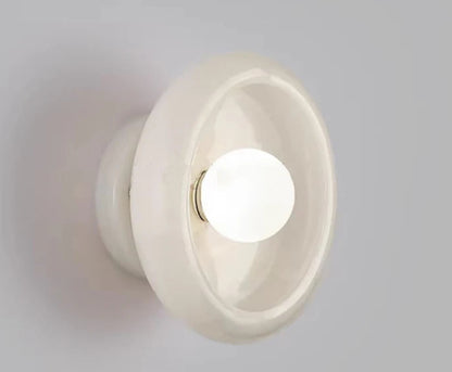 White Jade Wall Lamp turned on, emitting soft LED light and enhancing bedroom or living room ambiance with minimalist elegance.