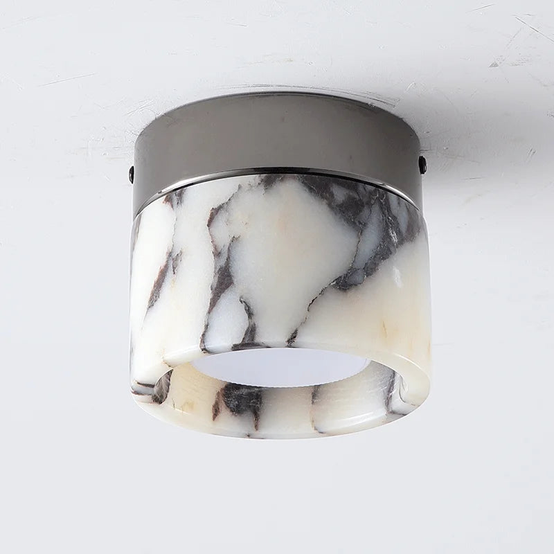 Close-up of Nordic LED wall sconce with marble-patterned glass and black metal top, perfect for hallways or modern interiors.
