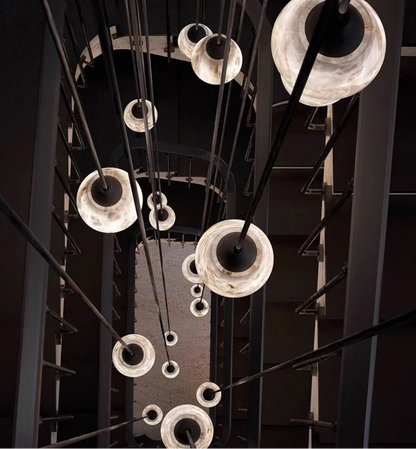 Top-down view of multiple marble LED pendant lights in stairwell. Marble LED pendant light – modern ceiling lamp dimmable for vertical spaces.