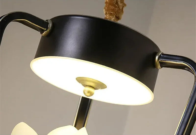 Top view of Magnolia Flower Pendant Light's ceiling mount in black and gold, part of retro-modern floral lighting design.