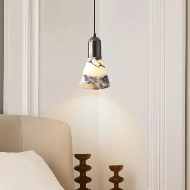 Dark Marble LED Pendant - Modern Ceiling Light installed above bedside table, offering warm dimmable lighting for cozy bedroom decor.