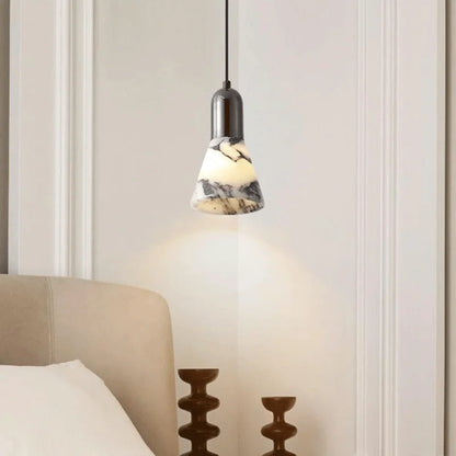 Dark Marble LED Pendant - Modern Ceiling Light installed above bedside table, offering warm dimmable lighting for cozy bedroom decor.