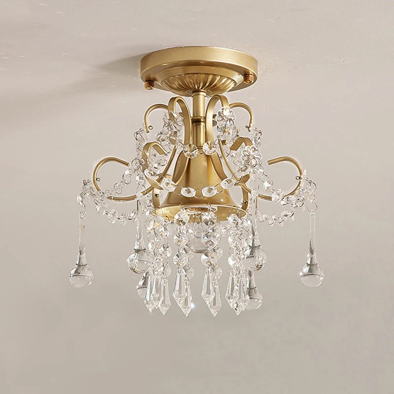 Vintage-style gold crystal chandelier lighting fixture with clear crystal accents, perfect for upscale interior decoration.