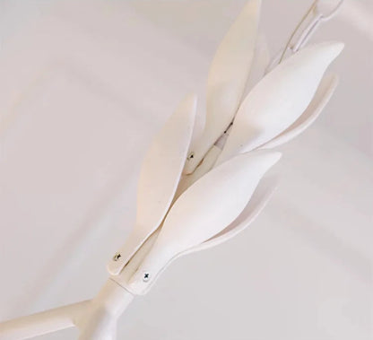 Leaf-shaped suspension detail of carved plaster chandelier - french farmhouse ceiling light, blending nature with elegance.