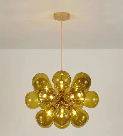 Amber bubble glass chandelier with black lampbody, a Scandinavian pendant light ideal for warm, modern interiors.
