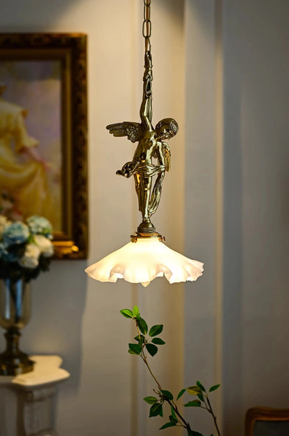 Lit Copper Angel Pendant Light with soft glow and ornate angel design, ideal chandelier for ambient dining or bedroom lighting.