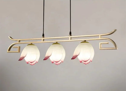 Three-light horizontal lotus flower LED pendant light with curved gold frame, ideal for kitchen islands or dining areas.