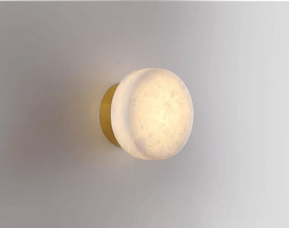 Modern LED Marble Wall Lamp with gold base and marble shade, offering a luxurious lighting option for living spaces.