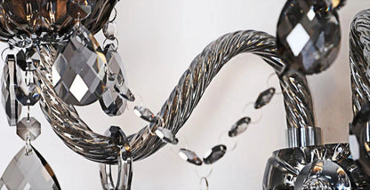 Close-up of twisted crystal arm and hanging droplets on vintage lotus wall sconce, showcasing intricate craftsmanship.