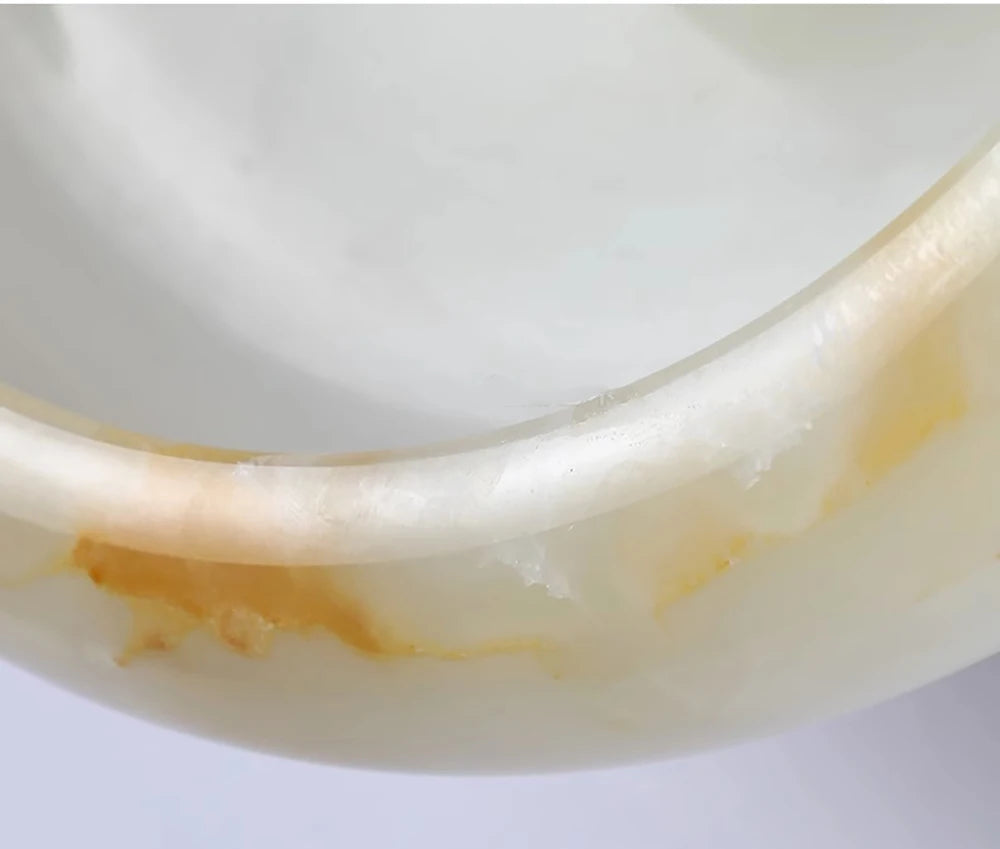 Close-up of natural marble used in Jade Wall Lamp, showcasing polished finish and rich texture for luxury home lighting.