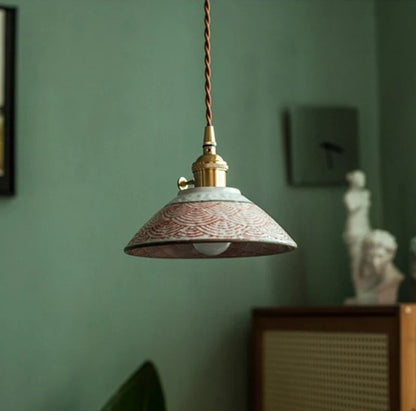 Interior view of red wave ceramic pendant lamp with LED bulb, showcasing hand-painted detailing and brass fixture.
