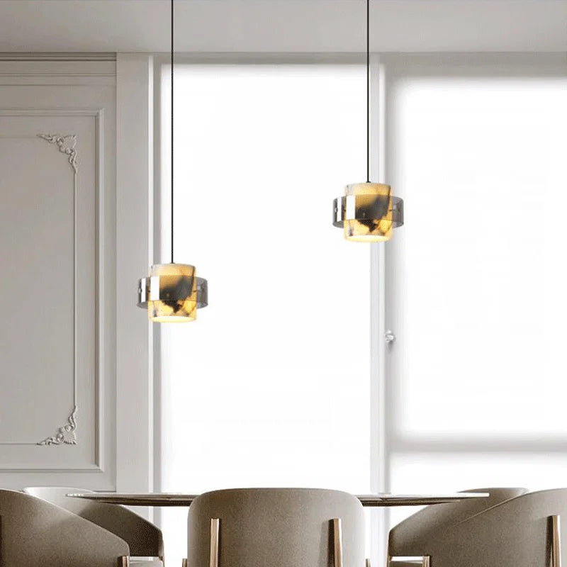 Pair of LED Marble Pendant Lights suspended over a dining area, offering a sleek and luxurious lighting solution for contemporary spaces.