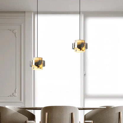 Pair of LED Marble Pendant Lights suspended over a dining area, offering a sleek and luxurious lighting solution for contemporary spaces.