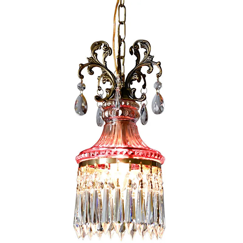 Brightly lit French crystal chandelier with red glass and ornate gold accents, luxury pendant light for elegant home décor.