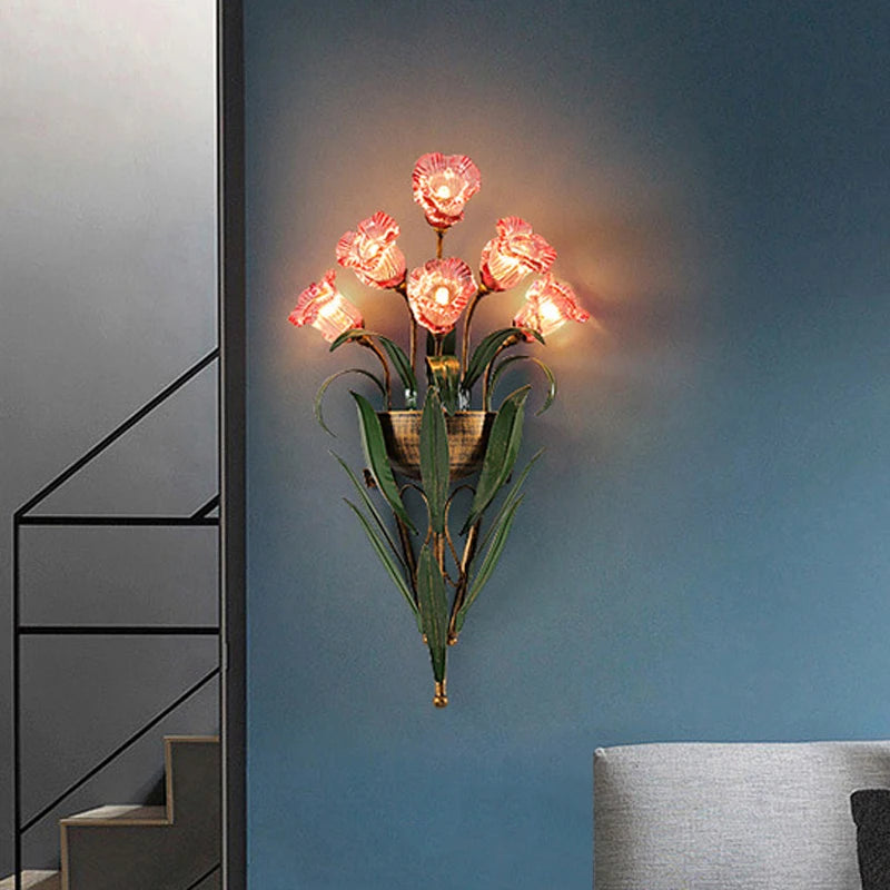 Pink glass flower wall light fixture in a cozy blue-toned room, adding a romantic French vintage touch to home decor.