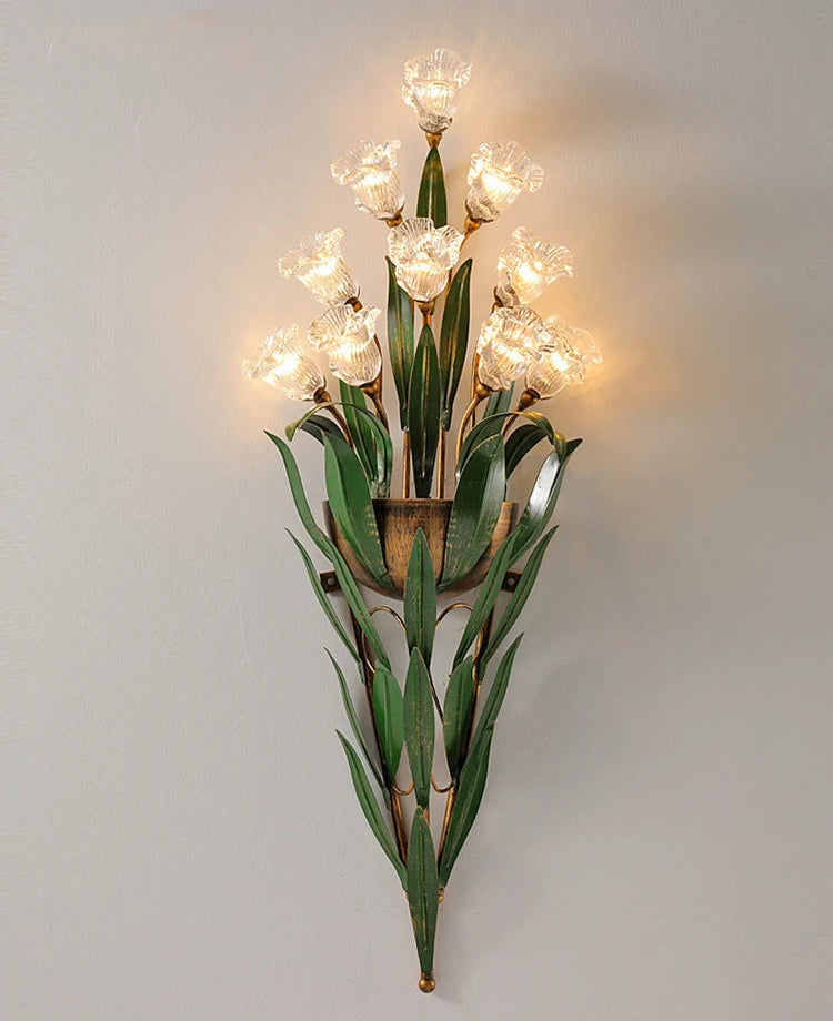 Vintage French floral wall light with clear glass flowers and green foliage, offering elegant lighting for hallways or bedrooms.