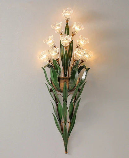 Vintage French floral wall light with clear glass flowers and green foliage, offering elegant lighting for hallways or bedrooms.