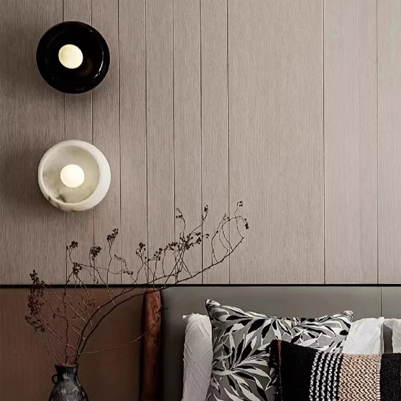 Black and white Jade Wall Lamps installed above a bed, adding a modern and luxurious touch to bedroom decor with ambient LED lighting.