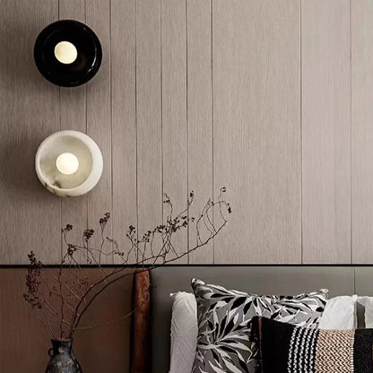 Black and white Jade Wall Lamps installed above a bed, adding a modern and luxurious touch to bedroom decor with ambient LED lighting.